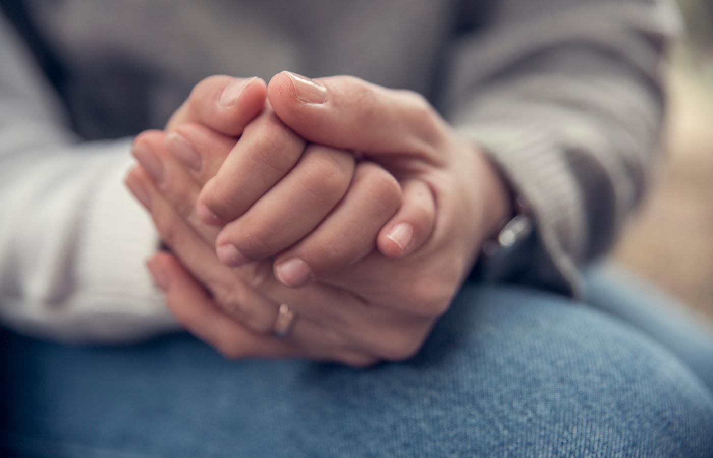 Mother and son holding hands close up shot